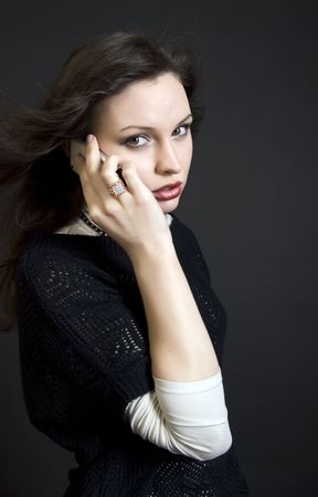 Portrait of a young beautiful brunette talking by the cell phoneの写真素材