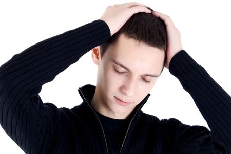 Portrait of a young dark-haired man with his hands on the headの写真素材