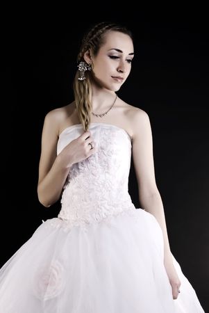Young beautiful bride in wedding dress over black の写真素材