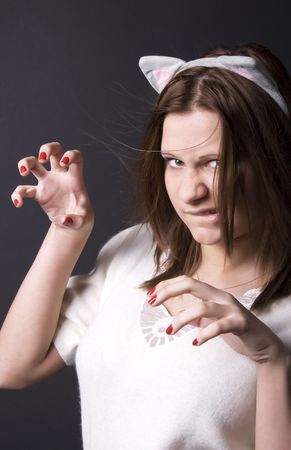 Portrait of a young beautiful girl imitating catの写真素材