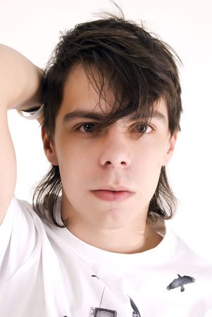 Young dark-haired man with thw hand behind the headの写真素材