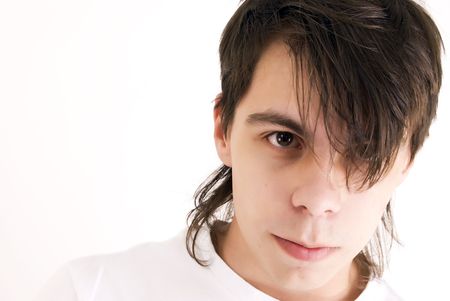 Young dark-haired man close-up isolated on whiteの写真素材