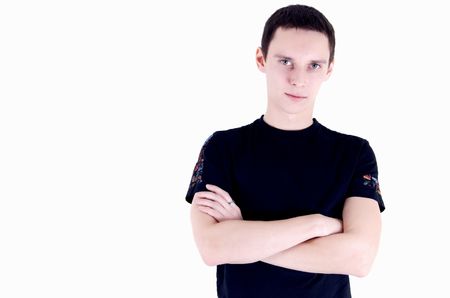 Portrait of a young dark-haired man with his arms foldedの写真素材