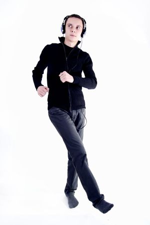 Young man in headphones and dancing with the musicの写真素材