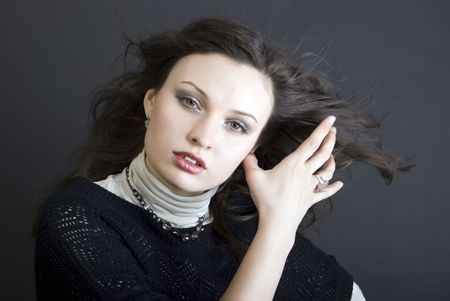 young beautiful seductive brunette with the hair blowing aboutの写真素材