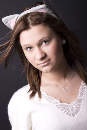 Portrait of a young beautiful girl with cats ears on the headの写真素材