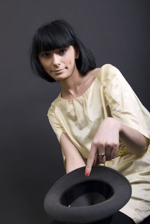 Young brunette holding an empty hat   symbolizing poverty and almsの写真素材