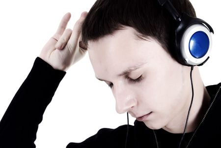 Young man in headphones relaxing under the sounds of musicの写真素材