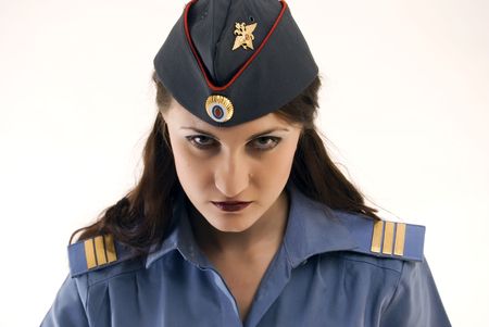 Young beautiful woman in police uniform being strict and seriousの写真素材