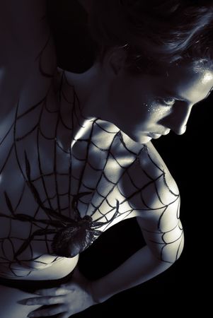 Young girl with bodyart spider and cobwebの写真素材