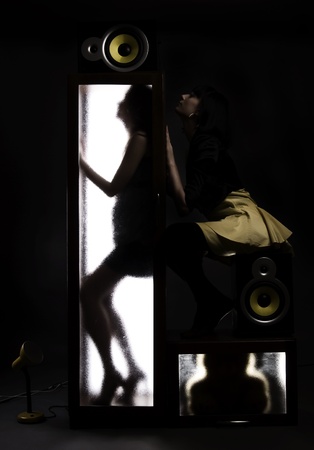 A girl behind the glass door  and sexy brunette near byの写真素材