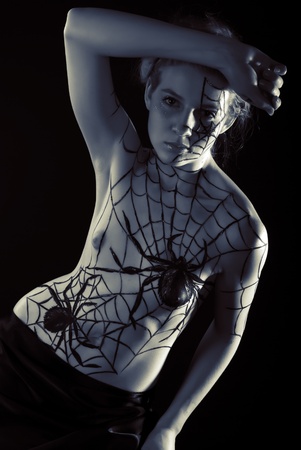 Young girl with bodyart spider and cobwebの写真素材
