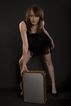 A beautiful brunette posing with  suitcase の写真素材