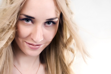 Portrait of a young seductive blonde smilingの写真素材