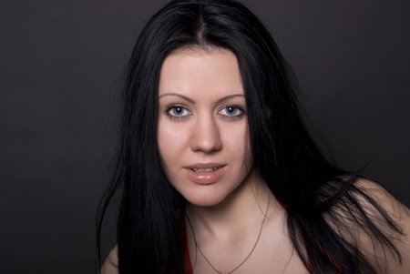 Portrait of a young seductive brunette over blackの写真素材