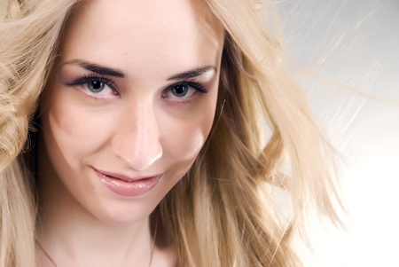 Portrait of a young seductive blonde over whiteの写真素材