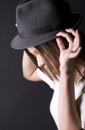 Portrait of a young beautiful brunette in hatの写真素材