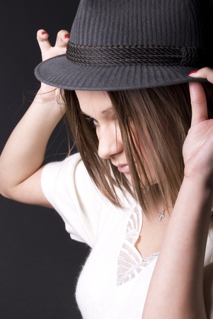 Portrait of a young seductive brunette in hatの写真素材