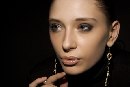 Portrait of a young seductive brunette over blackの写真素材