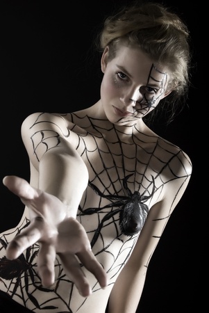Young girl with bodyart spider and cobwebの写真素材