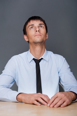 Portrait of an adult business man sitting in the office and daydreaming, planingの写真素材