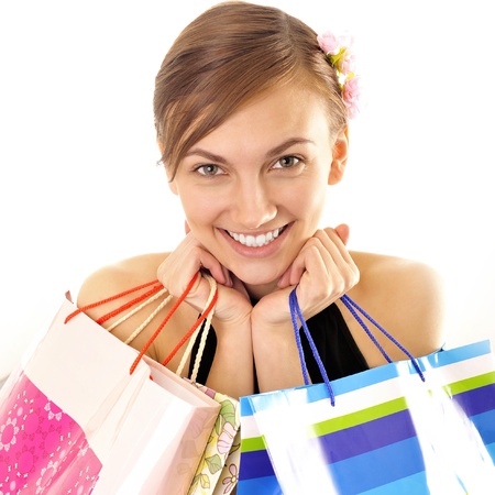Portrait of lovely woman with shopping bags over whiteの写真素材