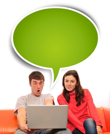 Portrait of a young couple using a computer. Isolated white background.の写真素材