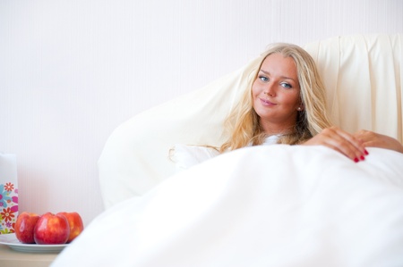 Portrait Of Young Woman Relaxing On Bedの写真素材