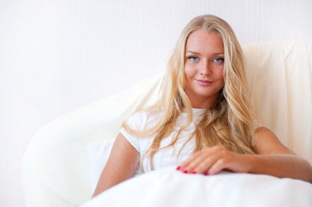 Portrait Of Young Woman Relaxing On Bedの写真素材