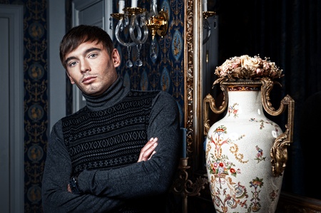 Elegant man posing in a stylish interiorの写真素材