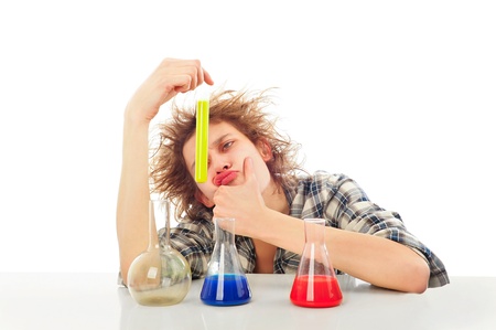 Portrait of funny young man with awesome hairdo isolated on white background. Working with color liquid in different glassware.の写真素材