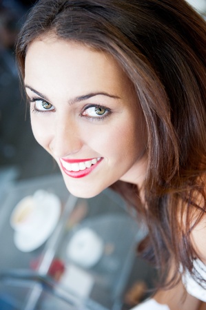 Closeup portrait of a pretty young female having a cup of coffeeの写真素材