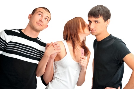Portrait of group of people - one girl with positive pregnancy test and two men thinking about paternityの写真素材