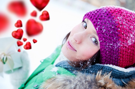 Beautiful and cheerful young lady in a happy mood outdoors in winterの写真素材