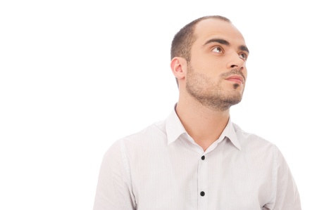 Thinking man isolated on white background. Closeup portrait of a casual young pensive businessman looking up. Caucasian male model.の写真素材