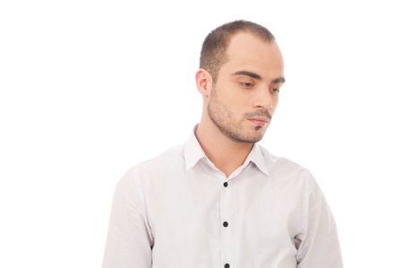 Portrait of young man looking down isolated on white backgroundの写真素材