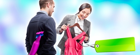 Portrait of adult beautiful couple shopping. Man gifting to his wife new dress and wine. Sale tag.の写真素材