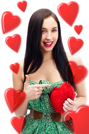 Young pretty attractive smiling woman with with soft heart toy isolated on white background. Holding Love Symbol and smilingの写真素材