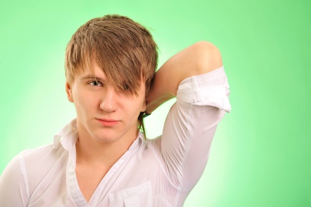 Portrait of a handsome young man over green backgroundの写真素材