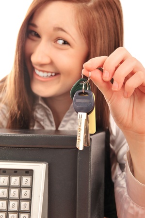 Closeup portrait of young pretty woman at her desk with deposit safe の写真素材