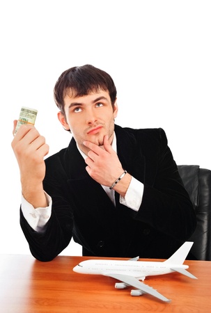 Portrait of young business man isolated on white background. Thinking about vacationの写真素材