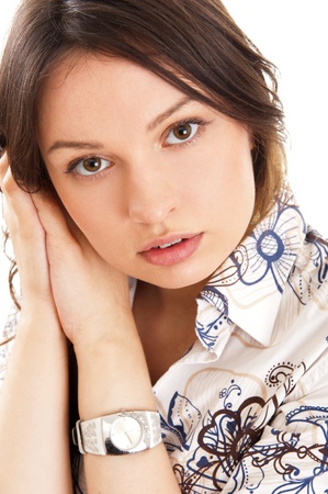 Beautiful European young woman standing with hands near cheek against white の写真素材