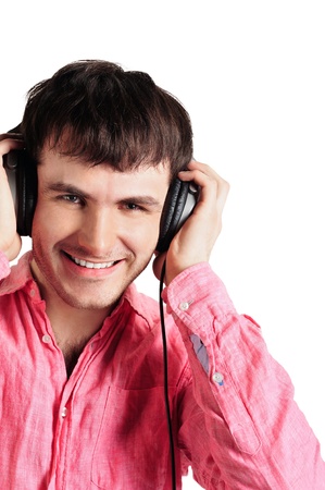 Young man wearing headphones and holding arms on them.の写真素材