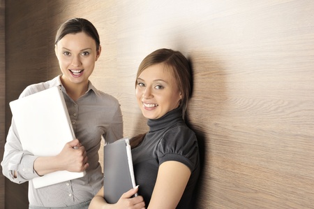 Portrait of two women in the hall. Office background.の写真素材