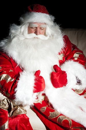 Santa sitting with a sack indoor at dark night roomの写真素材