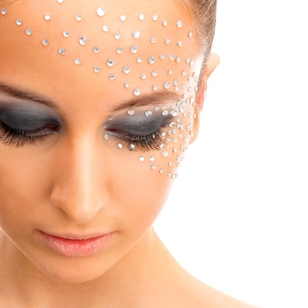 Portrait of young beautiful woman with crystals on face - isolated on white backgroundの写真素材