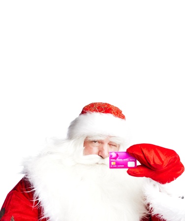 Traditional Santa Claus holding and sowing credit card while giving a big "ho ho ho" belly laugh. Isolated on white.の写真素材