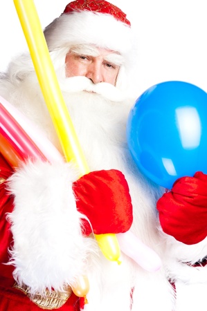 Traditional Santa Claus holding balloons for children. Isolated on white.の写真素材