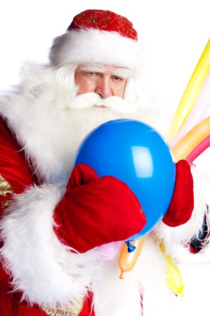 Traditional Santa Claus holding balloons for children. Isolated on white.の写真素材
