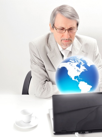 Portrait of an older businessman with a computer and a cup  Isolated white background の写真素材
